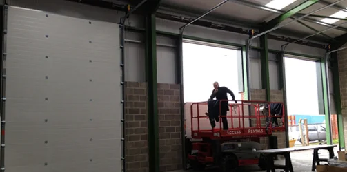 worker installing a garage door